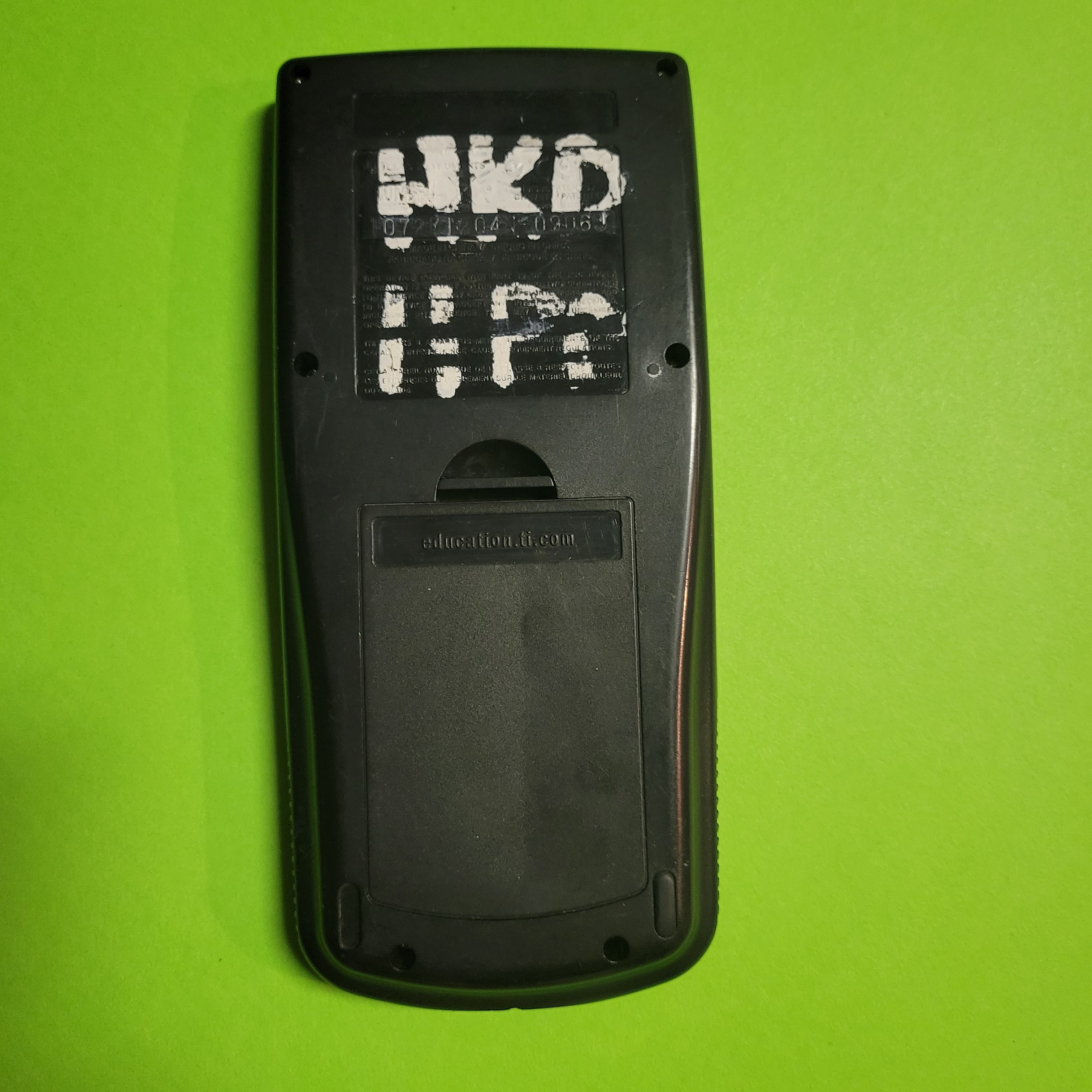 An image of the back of a texas instruments ti83 plus graphing calculator